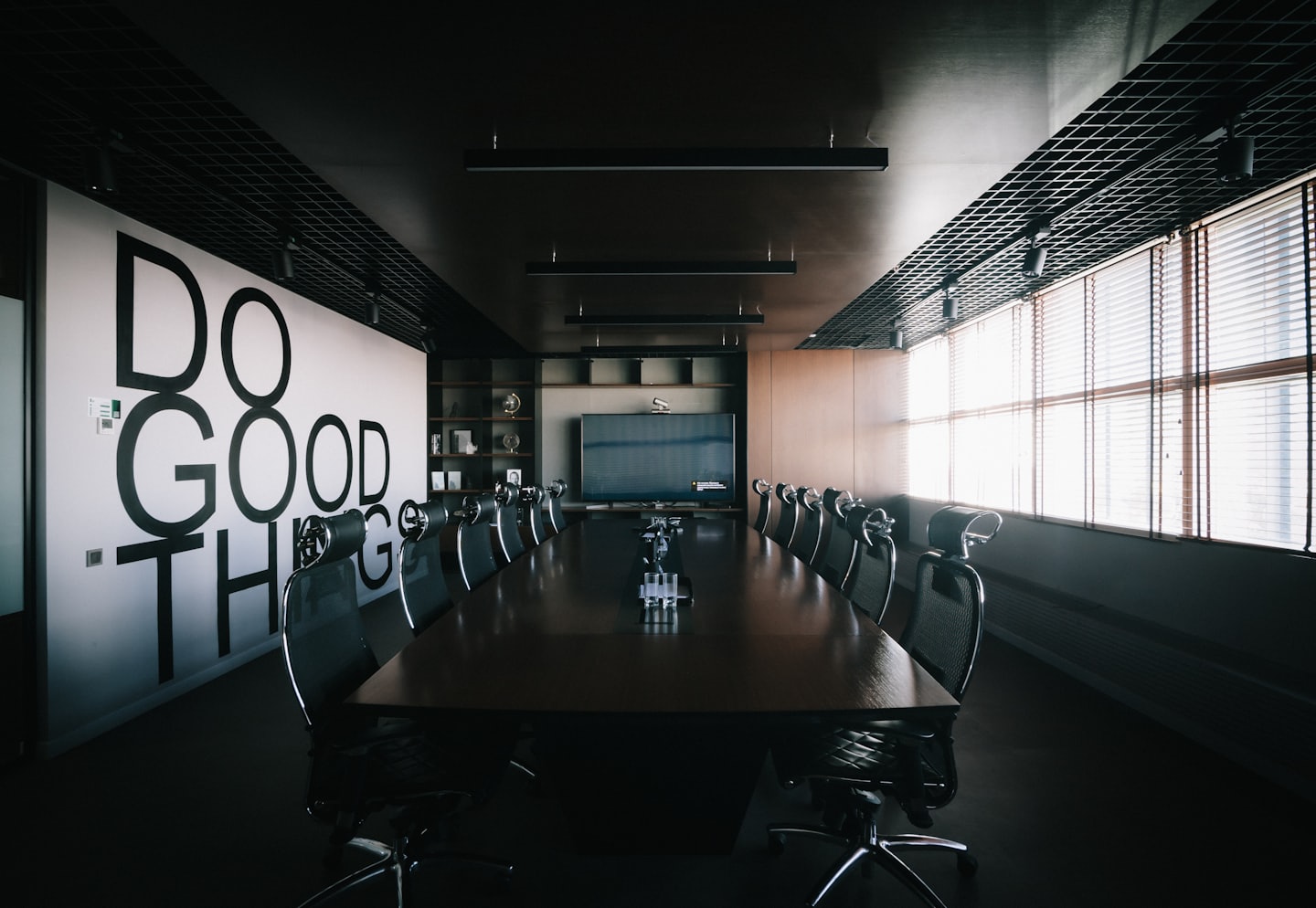Modern conference room with 'DO GOOD THINGS' on the wall.